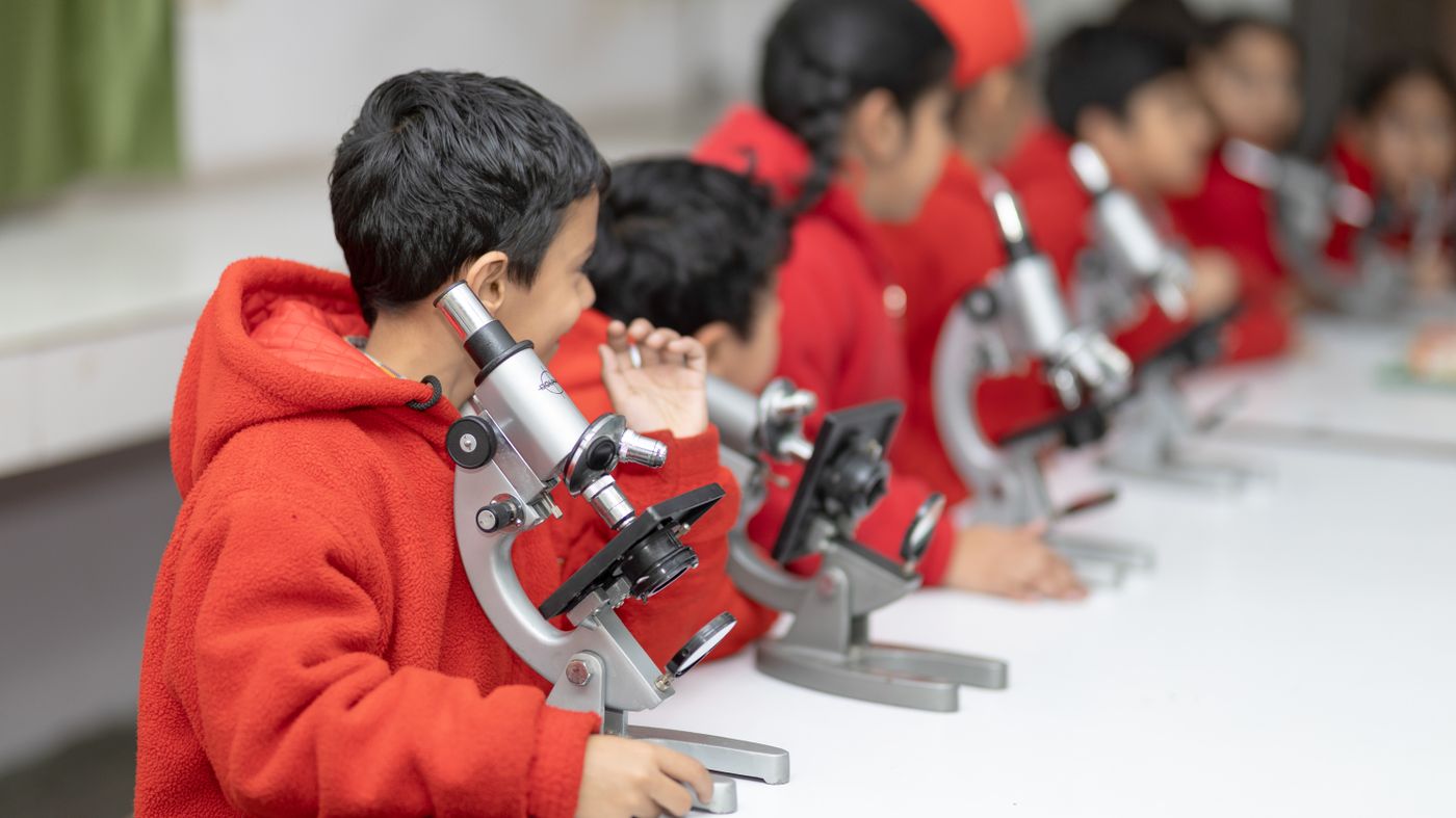 Students working at microscopes in the science laboratory