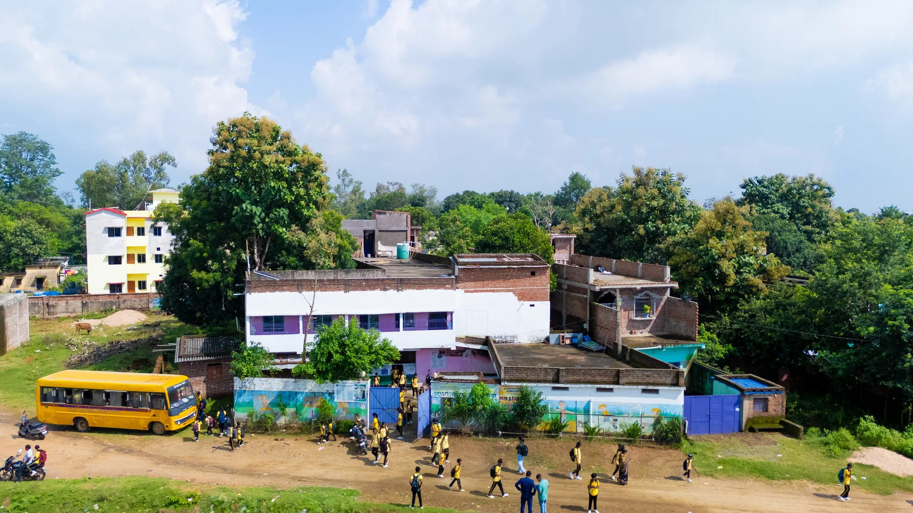 Wide aerial view of the campus and village