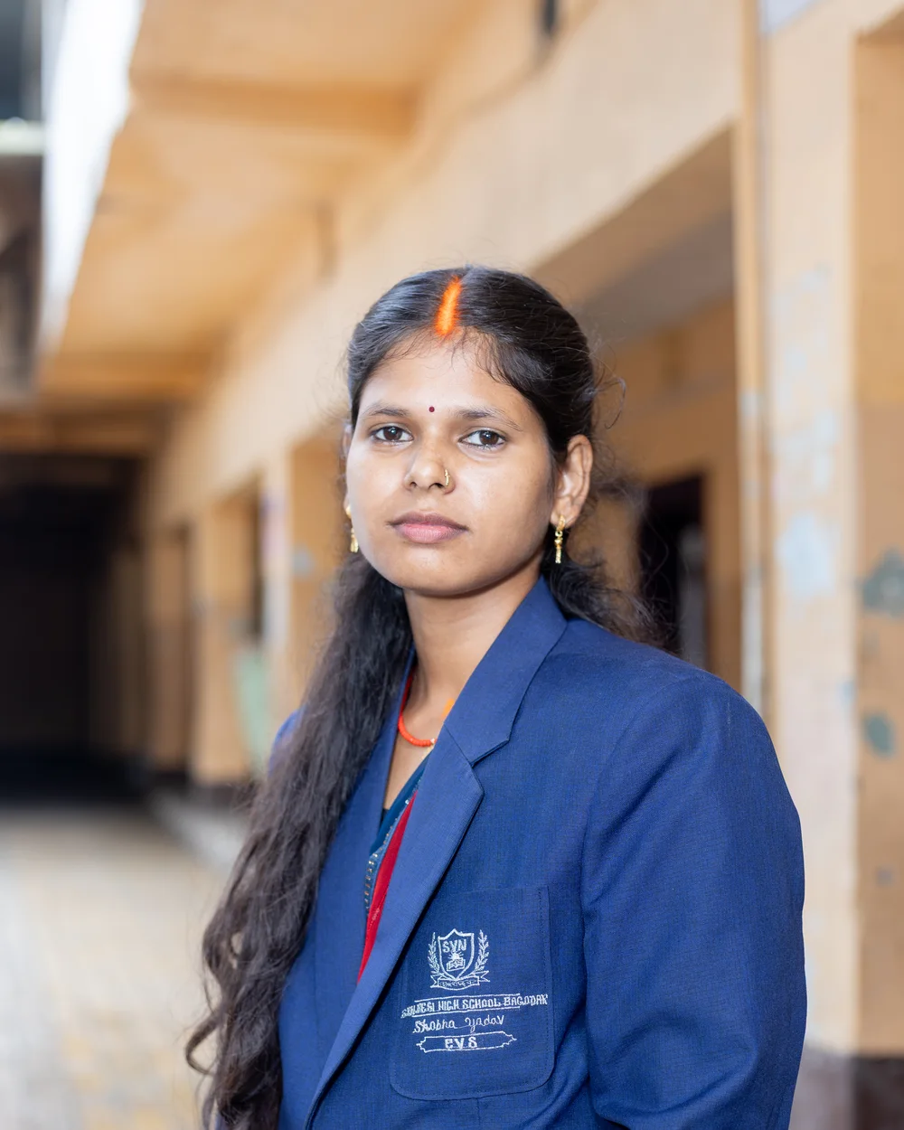 A member of the teaching staff photographed on the school verandah