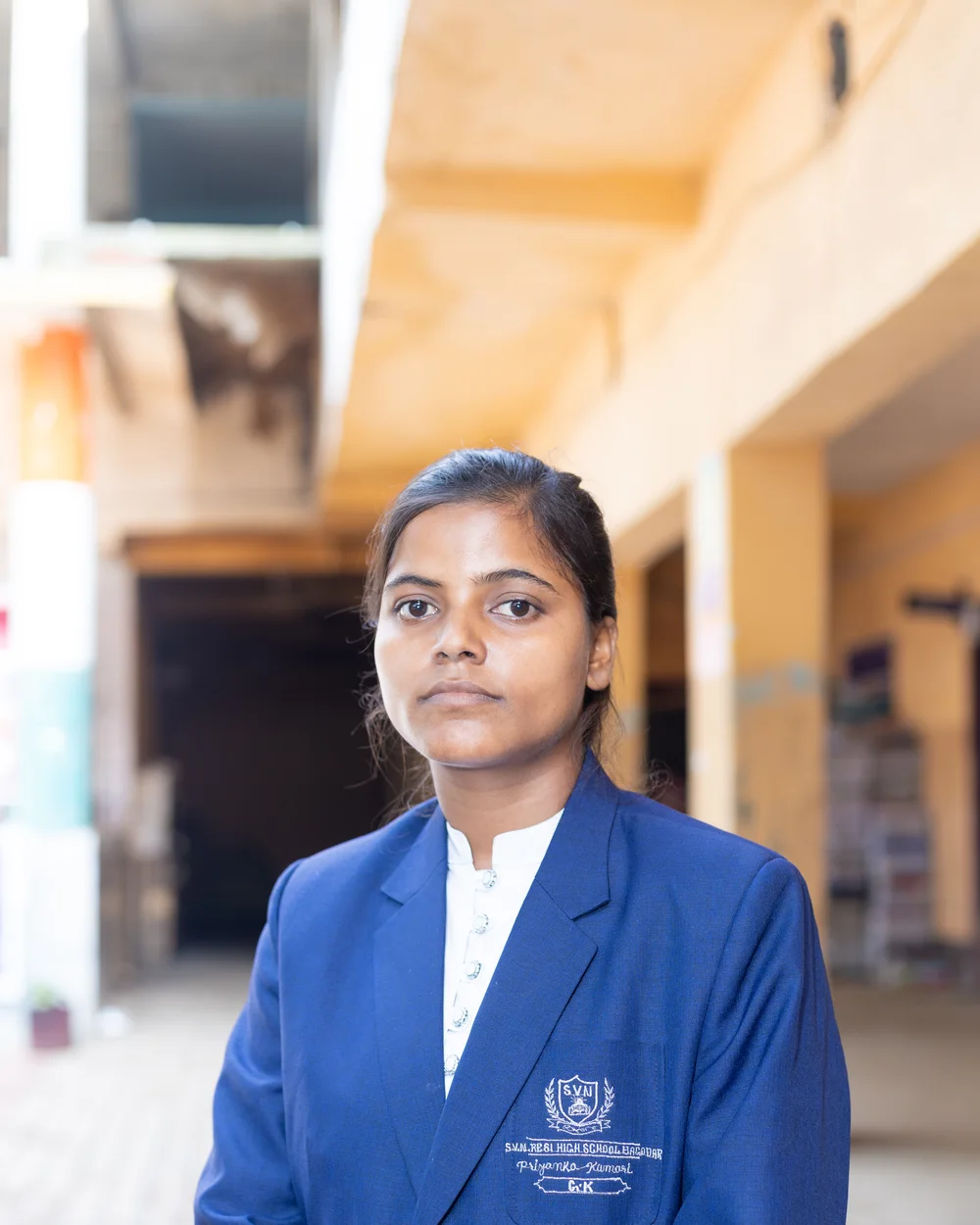 A member of the teaching staff photographed on the school verandah