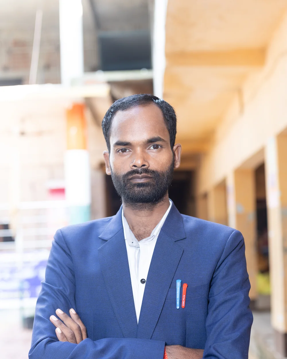 A member of the teaching staff photographed on the school verandah