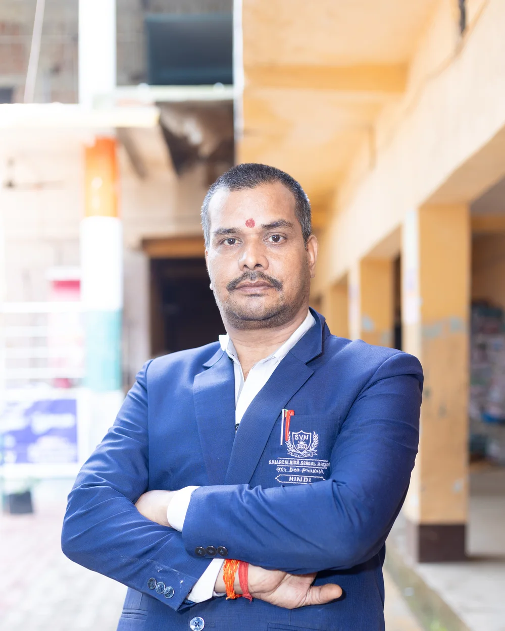 A member of the teaching staff photographed on the school verandah