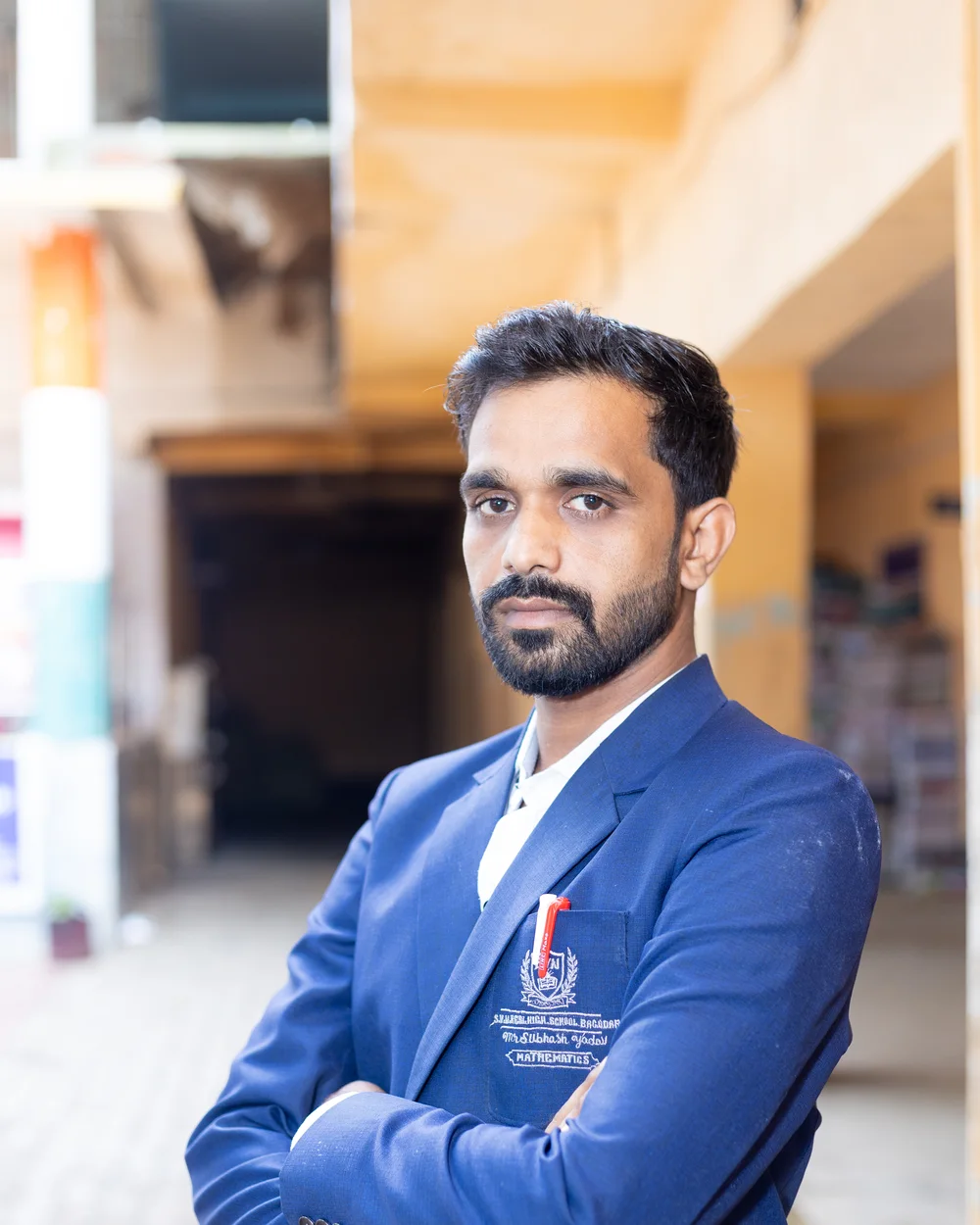 A member of the teaching staff photographed on the school verandah