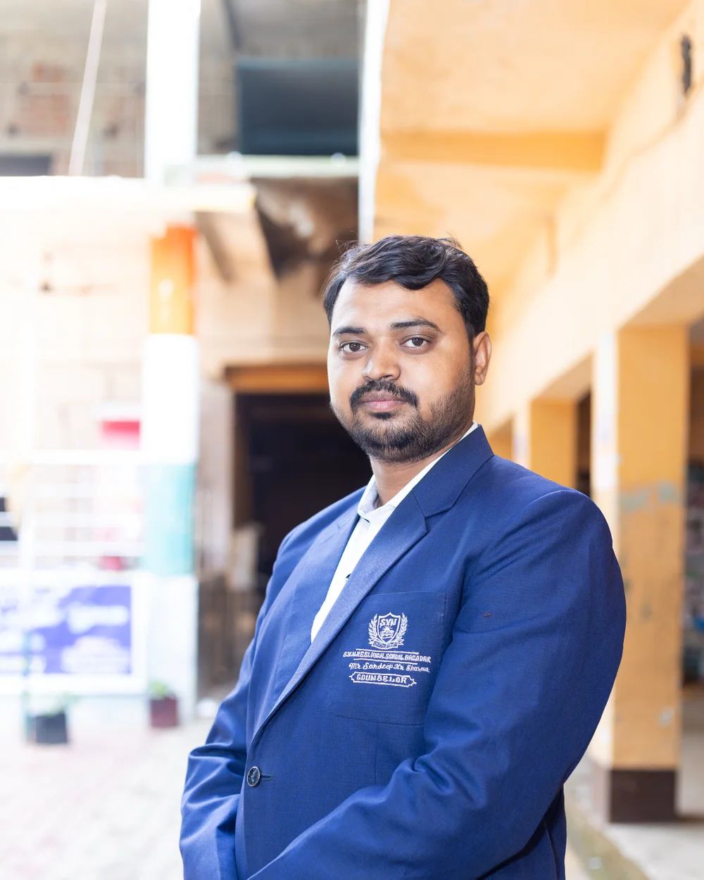 A member of the teaching staff photographed on the school verandah