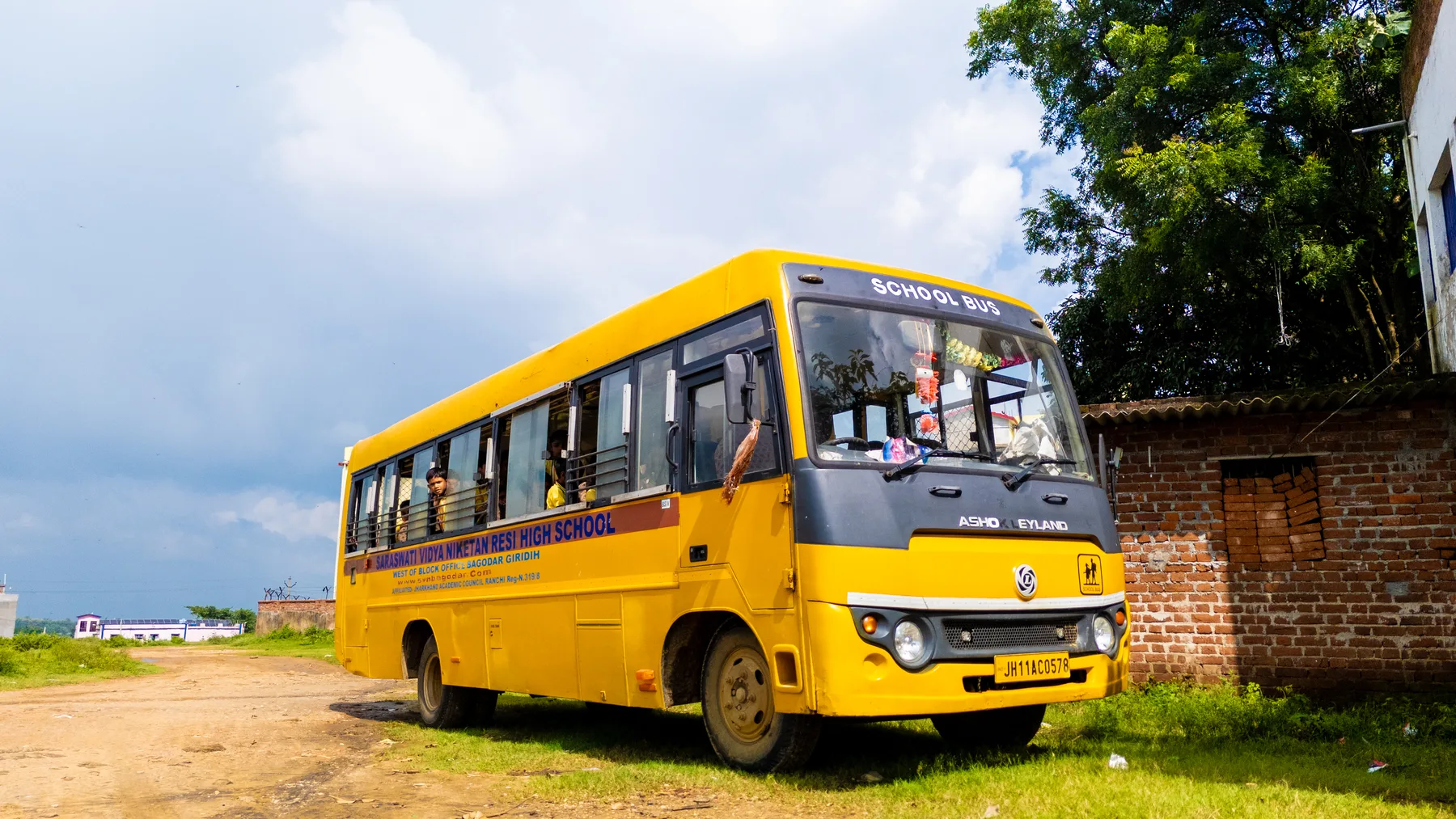 The school bus parked on the approach road